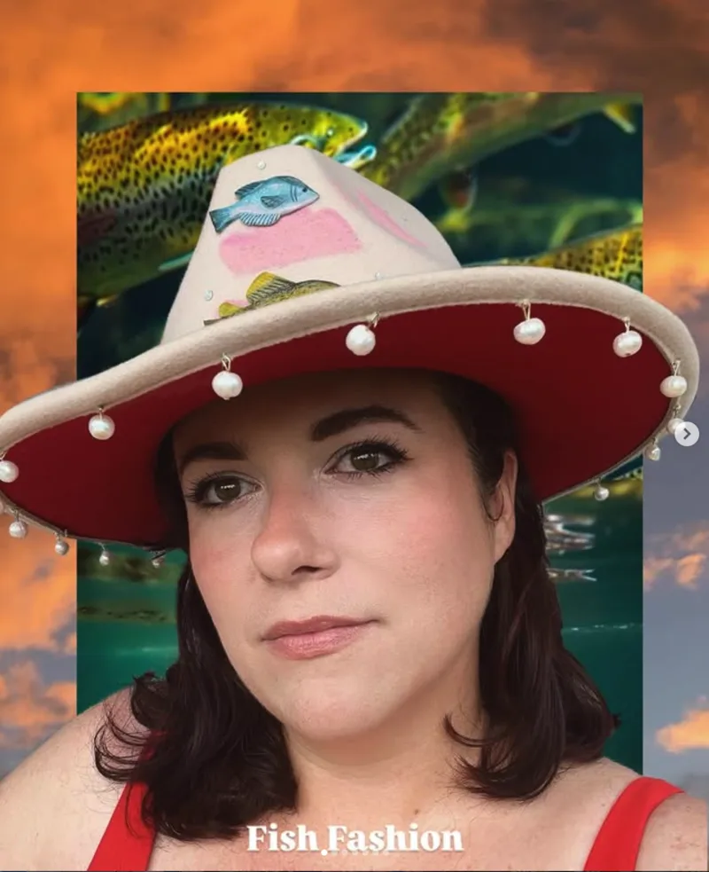 Casey Landerkin in a wide-brimmed hat topped with a handmade trout, against a sunset sky