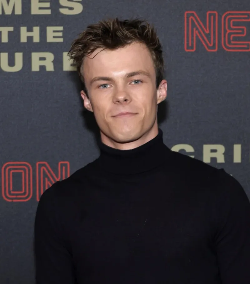 Nicholas Hamilton in a black turtleneck at a movie premiere