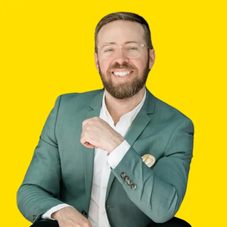 Nick Gray in a green suit against a bright yellow background